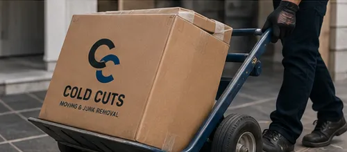 A labeled Cold Cuts moving box loaded on a hand truck